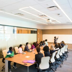 Professional team engaged in a collaborative boardroom meeting with a presentation in progress.
